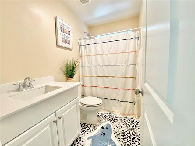 bathroom featuring toilet, vanity, tile patterned floors, and a shower with shower curtain