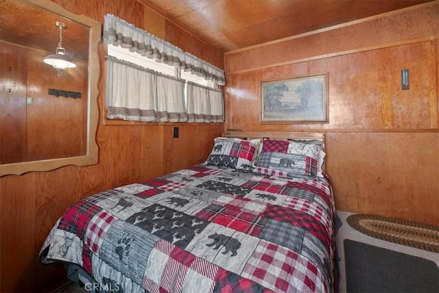bedroom featuring wooden walls