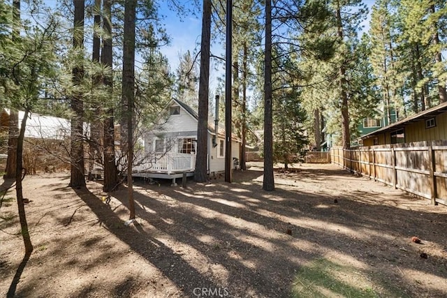 view of yard with fence and a wooden deck