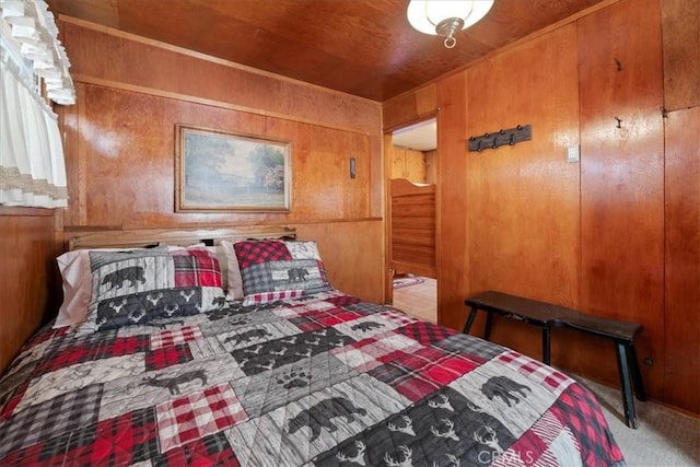 carpeted bedroom with wood walls