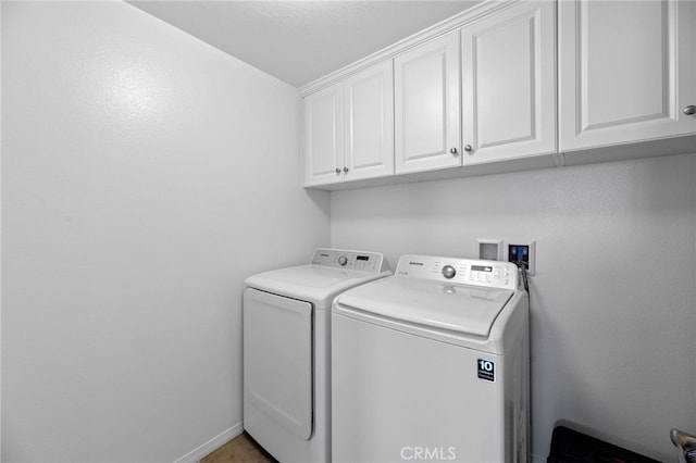 laundry room featuring cabinet space and washing machine and dryer