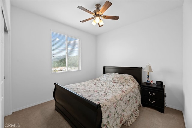 bedroom with a ceiling fan, carpet flooring, and baseboards