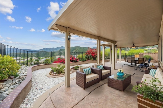 view of patio / terrace with a mountain view, outdoor lounge area, outdoor dining area, and a fenced backyard