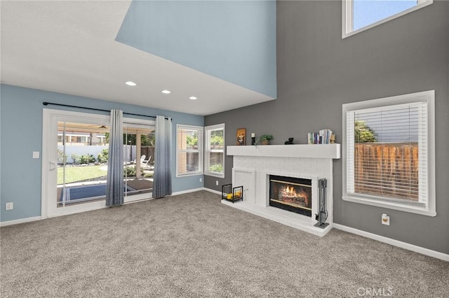 9334 Shamouti Dr, Riverside, CA 92508 - unfurnished living room featuring carpet flooring, a fireplace, baseboards, and recessed lighting