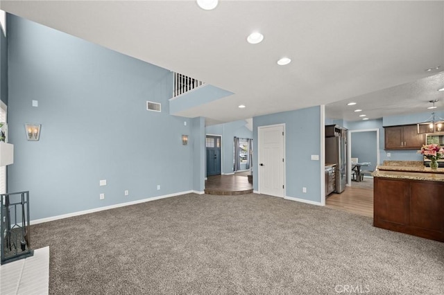 9334 Shamouti Dr, Riverside, CA 92508 - unfurnished living room featuring light colored carpet, baseboards, and recessed lighting