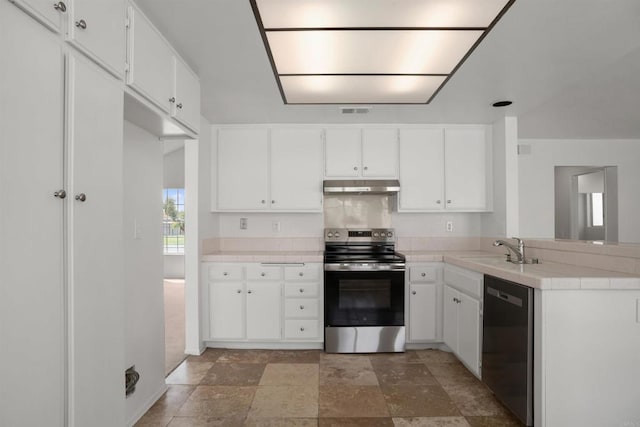 kitchen featuring appliances with stainless steel finishes, a sink, white cabinets, and under cabinet range hood