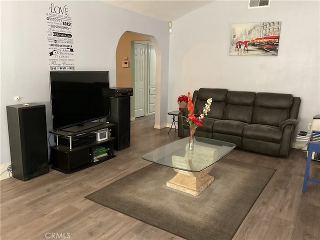 1391 N Crescent Ave, San Bernardino, CA 92405 - living room with arched walkways and wood finished floors