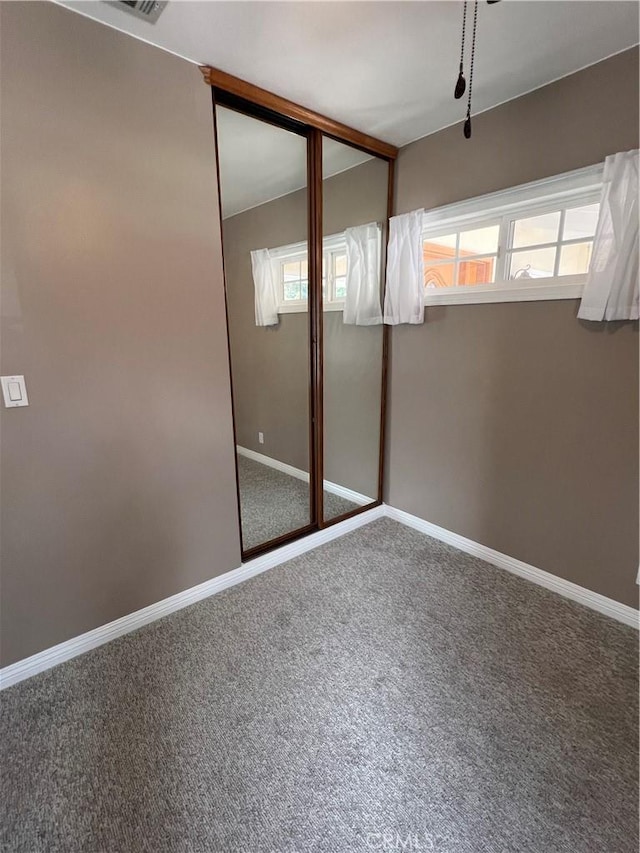 spare room with carpet and baseboards