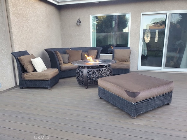 wooden deck with an outdoor fire pit