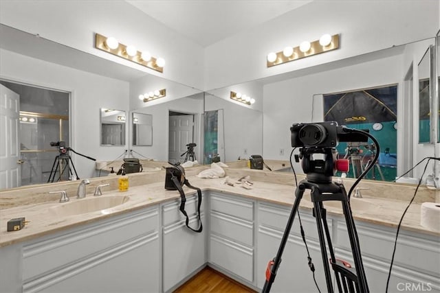 bathroom with wood finished floors and vanity