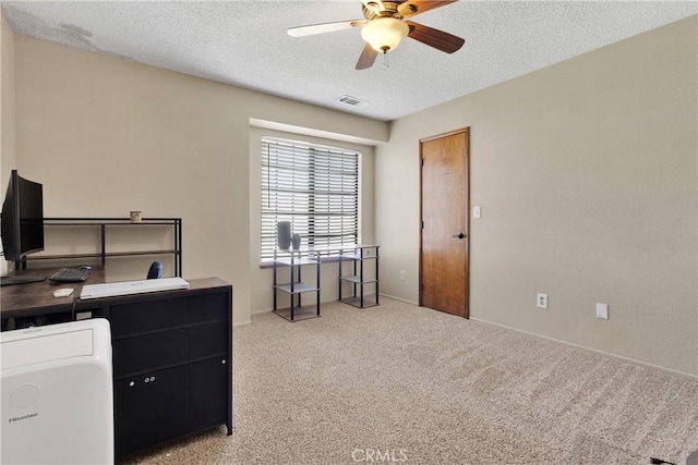 office area with carpet floors, ceiling fan, baseboards, visible vents, and a textured ceiling