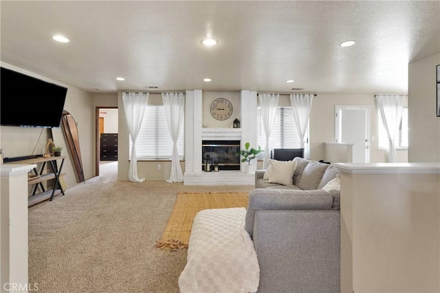living room with a fireplace, a healthy amount of sunlight, recessed lighting, and carpet flooring