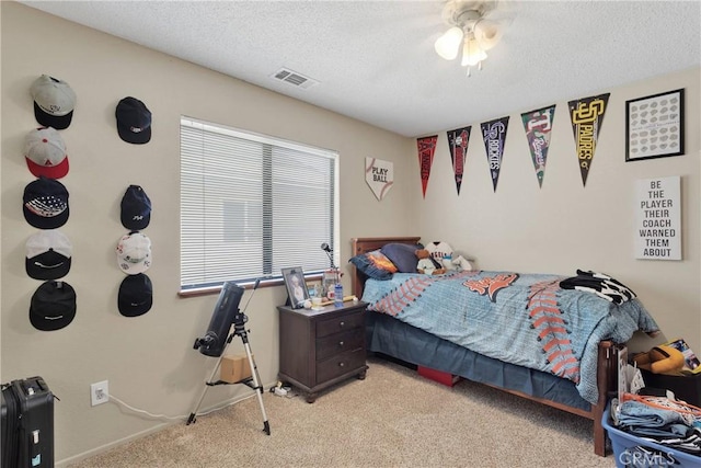 bedroom featuring baseboards, visible vents, light carpet, and a textured ceiling