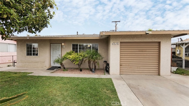 8737 Tilmont Ave, Pico Rivera, CA 90660 - ranch-style home featuring a front yard, fence, concrete driveway, an attached garage, and stucco siding