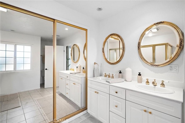 full bathroom featuring double vanity, a sink, tile patterned flooring, and recessed lighting