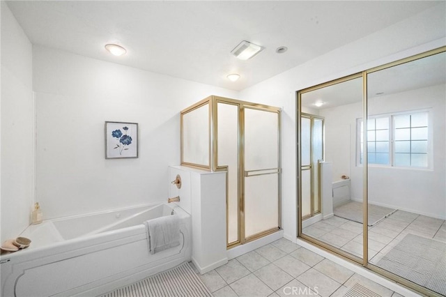full bath featuring tile patterned floors, a stall shower, and a bath