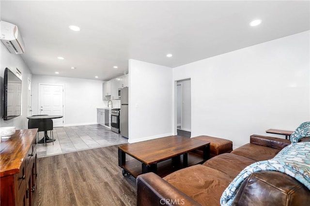 living area featuring baseboards, recessed lighting, dark wood-type flooring, and an AC wall unit