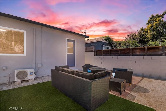 patio terrace at dusk with an outdoor hangout area, ac unit, and fence