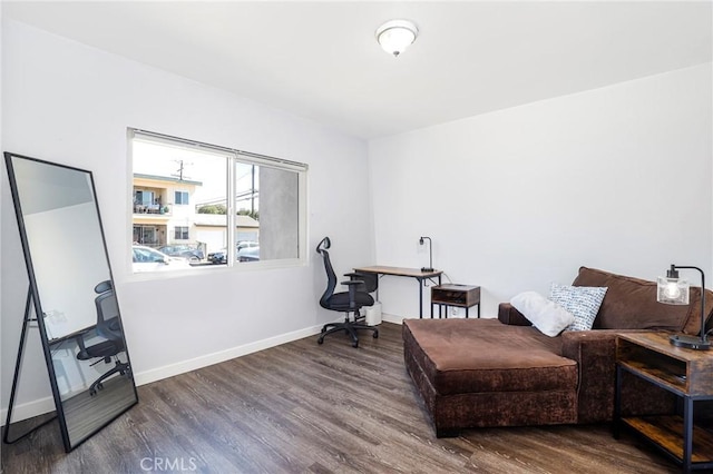 sitting room with baseboards and wood finished floors