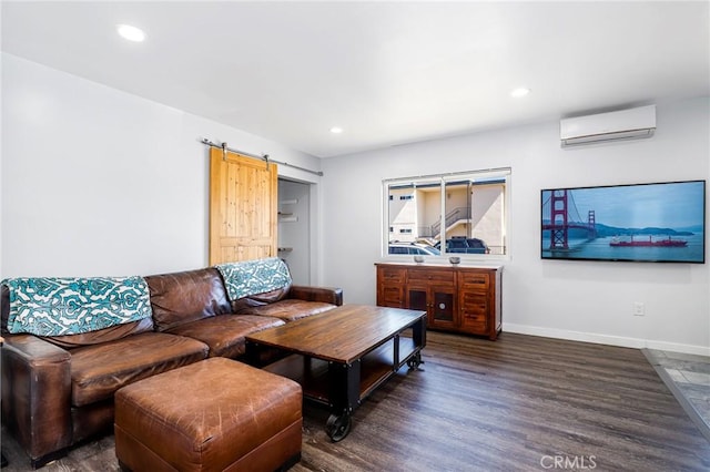 living area with recessed lighting, a barn door, an AC wall unit, baseboards, and dark wood-type flooring