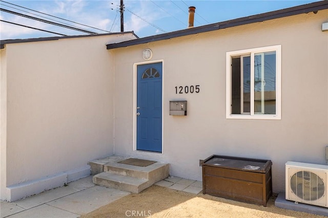 property entrance with stucco siding