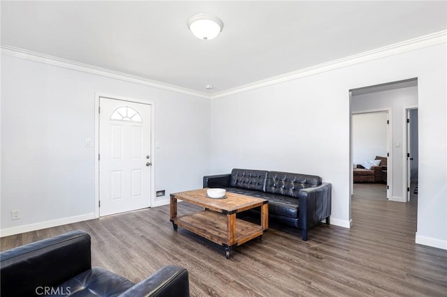 living area featuring wood finished floors, ornamental molding, and baseboards