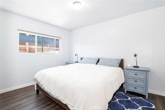bedroom featuring dark wood-type flooring and baseboards