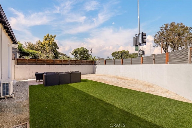 view of yard featuring a patio, an outdoor living space, a fenced backyard, and ac unit