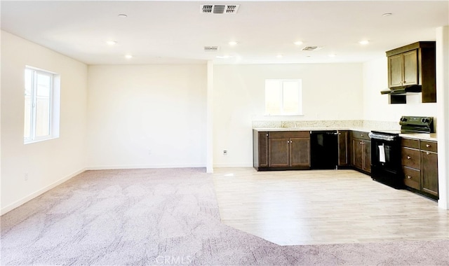 368 Arpent Ct, Merced, CA 95341 - kitchen with black appliances, light countertops, light colored carpet, dark brown cabinets, and recessed lighting