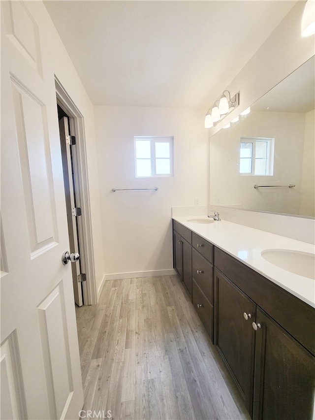 368 Arpent Ct, Merced, CA 95341 - bathroom featuring double vanity and wood finished floors