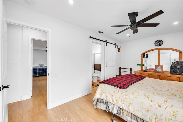 26414 Mehaffey St, Menifee, CA 92586 - bedroom featuring recessed lighting, light wood-style flooring, a barn door, and baseboards