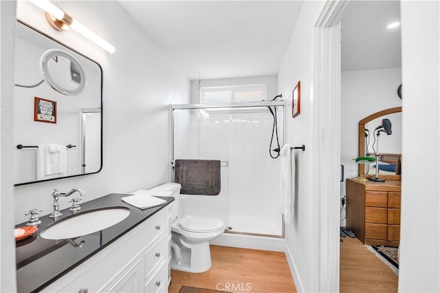 26414 Mehaffey St, Menifee, CA 92586 - full bathroom featuring wood finished floors, a shower stall, toilet, and vanity