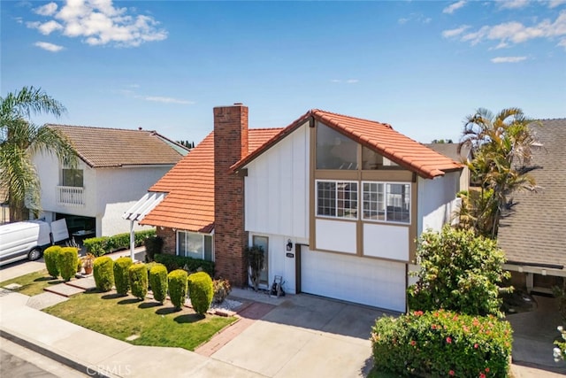 4200 Avenida Sevilla, Cypress, CA 90630 - view of front of home featuring a chimney, a garage, driveway, board and batten siding, and a tiled roof