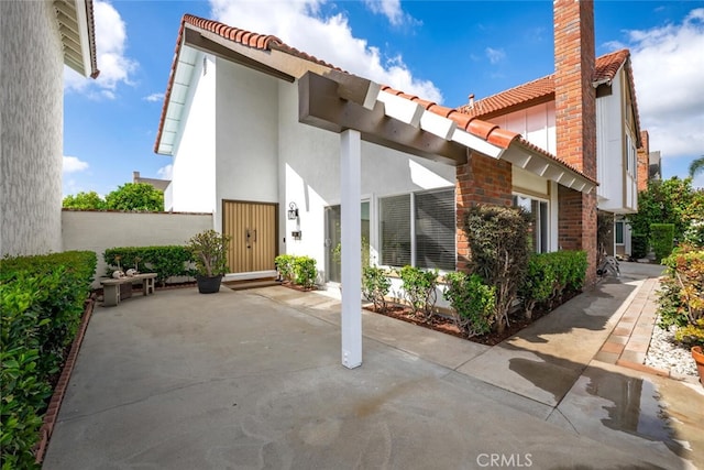 4200 Avenida Sevilla, Cypress, CA 90630 - rear view of house with a tile roof, stucco siding, a patio area, and brick siding