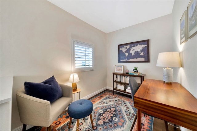 office area with baseboards and wood finished floors