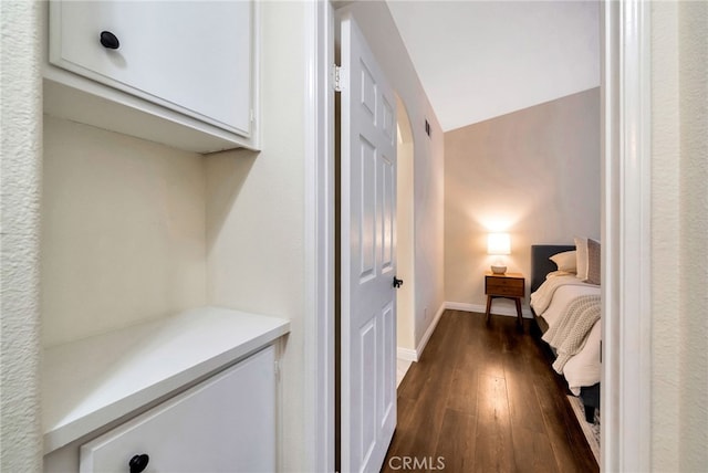 bedroom featuring baseboards and dark wood finished floors