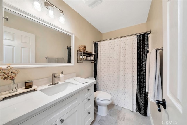 bathroom with vanity, toilet, and curtained shower