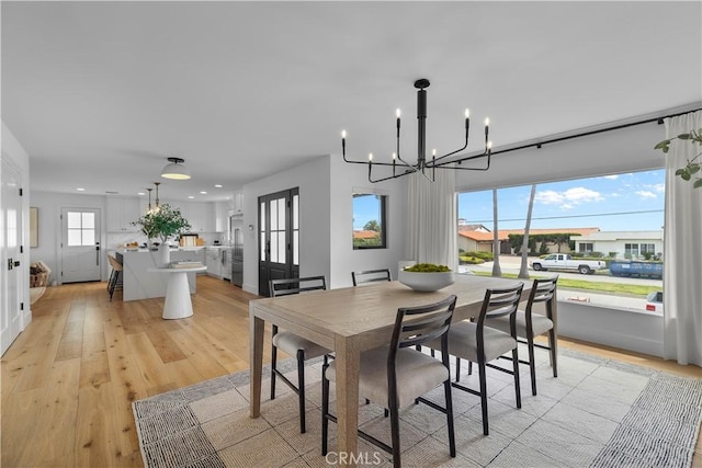 dining room featuring recessed lighting, a notable chandelier, and light wood-type flooring