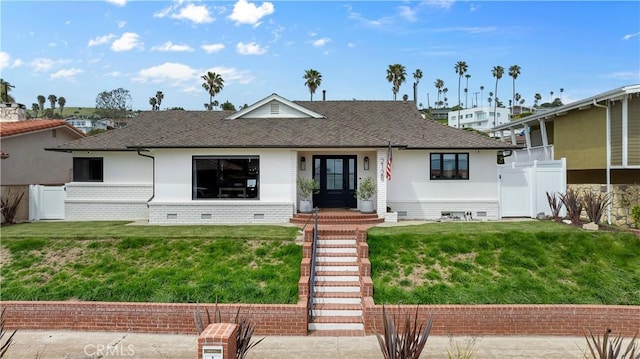 view of front of home with fence, a shingled roof, a front yard, and crawl space