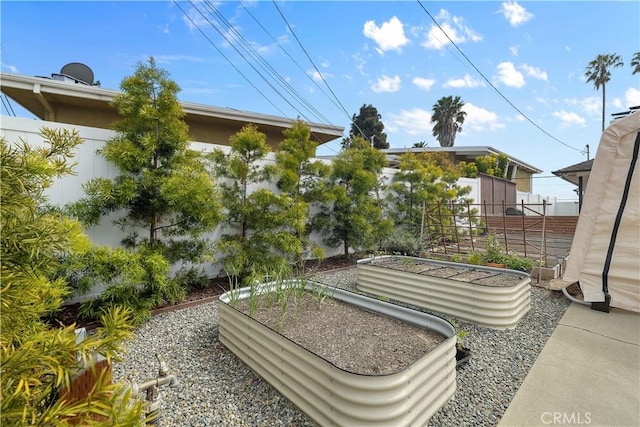 view of yard with a vegetable garden and fence