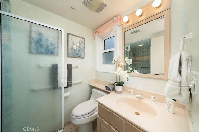 bathroom with toilet, visible vents, vanity, and a stall shower