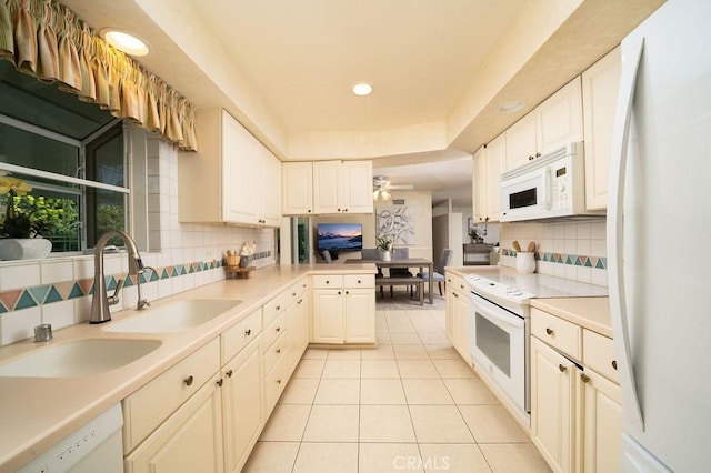 kitchen featuring tasteful backsplash, recessed lighting, white appliances, light countertops, and light tile patterned flooring