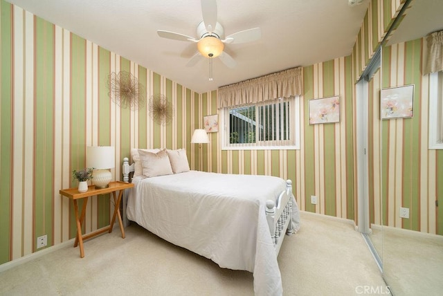 bedroom with a ceiling fan and light carpet