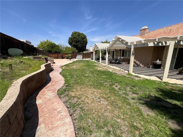 view of yard with a patio, a fenced backyard, and a pergola