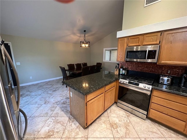 kitchen with decorative backsplash, a peninsula, dark stone countertops, lofted ceiling, and stainless steel appliances