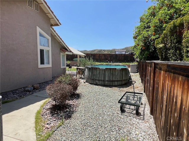 view of yard featuring a fenced in pool and a fenced backyard