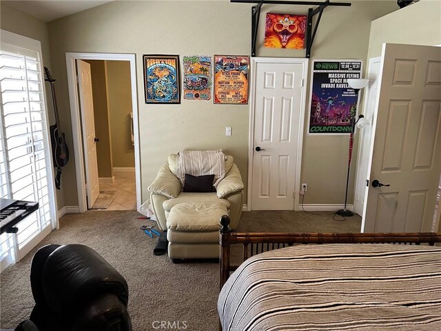 carpeted bedroom featuring baseboards, multiple windows, and vaulted ceiling