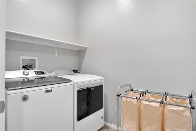 clothes washing area with separate washer and dryer and laundry area