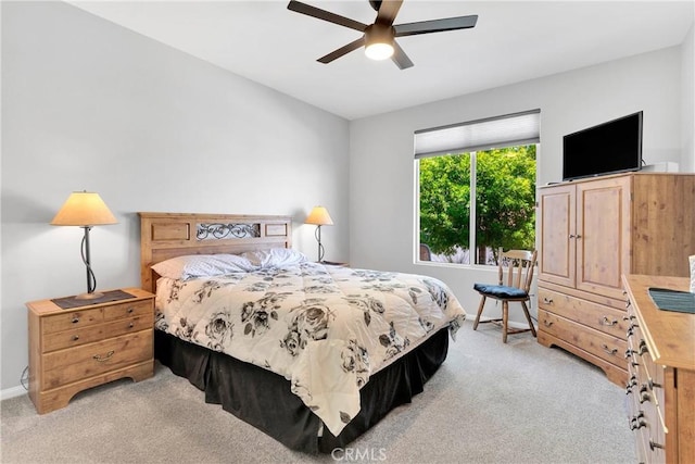 bedroom featuring light carpet and a ceiling fan