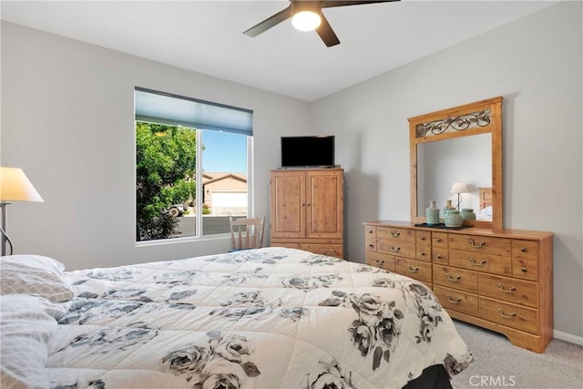 bedroom featuring baseboards, ceiling fan, and light carpet